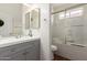 Bright bathroom with a shower-over-tub, grey cabinets, and a large mirror at 15034 N 30Th St, Phoenix, AZ 85032