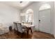 Bright dining area featuring modern lighting, a glass-top table, and arched windows for natural light at 15034 N 30Th St, Phoenix, AZ 85032