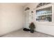 Welcoming front porch with decorative seasonal planter, arched window, and security screen door at 15034 N 30Th St, Phoenix, AZ 85032