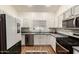 Bright kitchen with stainless steel appliances, updated cabinets, stone countertops, and a window over the sink at 15034 N 30Th St, Phoenix, AZ 85032