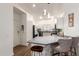 Cozy kitchen featuring stone countertops, barstool seating, modern lighting, and stainless steel appliances at 15034 N 30Th St, Phoenix, AZ 85032