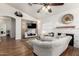 Comfortable living room with cozy fireplace, wood floors, a stylish ceiling fan, and modern decor at 15034 N 30Th St, Phoenix, AZ 85032