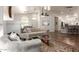 Spacious living area with a cozy sofa, modern decor, ceiling fan, and open access to the kitchen at 15034 N 30Th St, Phoenix, AZ 85032