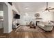 Bright open-concept living room featuring stylish decor, ceiling fan, fireplace, and wood flooring at 15034 N 30Th St, Phoenix, AZ 85032