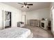Cozy main bedroom with fireplace, accent chair, and adjacent bathroom entrance at 15034 N 30Th St, Phoenix, AZ 85032