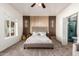 Spacious main bedroom with a stylish accent wall, ceiling fan, and ensuite bathroom at 15034 N 30Th St, Phoenix, AZ 85032