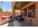 Covered back patio with outdoor seating and views of the landscaped backyard at 1534 E Mineral Rd, Gilbert, AZ 85234