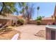 Enclosed backyard featuring a brick patio and mature desert landscaping, ideal for privacy at 1534 E Mineral Rd, Gilbert, AZ 85234