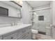 Bright bathroom featuring a glass door shower, white double sink vanity and modern fixtures at 1534 E Mineral Rd, Gilbert, AZ 85234