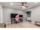 Spacious bedroom with a ceiling fan, wood-look tile floors, and seamless access to an adjacent sleeping area at 1534 E Mineral Rd, Gilbert, AZ 85234