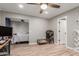 Bedroom featuring wood-look floors, a ceiling fan, and convenient access to an adjacent room, enhancing versatility at 1534 E Mineral Rd, Gilbert, AZ 85234