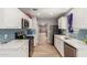 Well-equipped kitchen featuring white cabinets, blue subway tile, stainless steel appliances, and wood-look tile at 1534 E Mineral Rd, Gilbert, AZ 85234