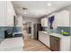 Stylish kitchen with stainless steel appliances, white cabinets, and blue tile backsplash, offering modern functionality at 1534 E Mineral Rd, Gilbert, AZ 85234