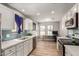 Bright kitchen featuring modern appliances, white cabinetry, subway tile backsplash, and seamless flow to home office at 1534 E Mineral Rd, Gilbert, AZ 85234