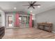 Spacious living room with wood floors, a ceiling fan, and a glass panel door at 1534 E Mineral Rd, Gilbert, AZ 85234