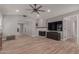 Bright living room with hardwood floors, a fireplace, a ceiling fan, and recessed lights at 1534 E Mineral Rd, Gilbert, AZ 85234