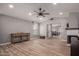 Spacious living room with wood floors, a ceiling fan, recessed lighting and a view into other living spaces at 1534 E Mineral Rd, Gilbert, AZ 85234