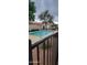 A beautiful community pool offers a relaxing space surrounded by trees and a wrought iron fence at 16021 N 30Th St # 113, Phoenix, AZ 85032