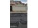 Exterior view of a tan townhome with a one car garage, complimented by desert landscaping at 16021 N 30Th St # 113, Phoenix, AZ 85032