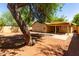 Spacious backyard featuring covered patio and mature landscaping at 16118 W Morning Glory St, Goodyear, AZ 85338