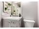 Updated bathroom boasts a vanity with a white countertop and stylish decor at 16118 W Morning Glory St, Goodyear, AZ 85338