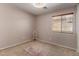Bedroom featuring plush carpet, large window with wood trim, and a chair at 16118 W Morning Glory St, Goodyear, AZ 85338