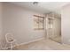 Bedroom with carpet, a window, chair, and mirrored closet doors at 16118 W Morning Glory St, Goodyear, AZ 85338