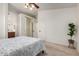 Open bedroom with connecting bathroom, closet, and decorative fig tree at 16118 W Morning Glory St, Goodyear, AZ 85338