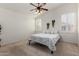 Bright bedroom featuring plantation shutters, ceiling fan, and decorative accents at 16118 W Morning Glory St, Goodyear, AZ 85338