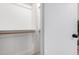 Open walk-in closet featuring a wooden clothes bar and access to an adjoining room at 16118 W Morning Glory St, Goodyear, AZ 85338