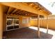Inviting covered patio with pavers and charming string lights for cozy outdoor living at 16118 W Morning Glory St, Goodyear, AZ 85338