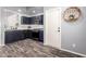 Kitchen with stainless steel appliances, stylish blue cabinets, and wood-look flooring at 16118 W Morning Glory St, Goodyear, AZ 85338