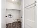 Laundry room features wood-look floors, white walls, and storage at 16118 W Morning Glory St, Goodyear, AZ 85338