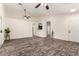 Spacious living room features wood-look floors, ceiling fans, and an open floor plan at 16118 W Morning Glory St, Goodyear, AZ 85338