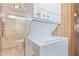 An in-unit washer/dryer combo, paired with a bathtub and a standard height toilet at 17200 W Bell Rd # 2189, Surprise, AZ 85374