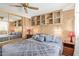 This cozy bedroom features ample storage with mirrored closets and wood cabinets above the bed at 17200 W Bell Rd # 2189, Surprise, AZ 85374