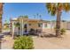 Charming home featuring a covered patio and a well-maintained gravel yard with mature landscaping at 17200 W Bell Rd # 2189, Surprise, AZ 85374