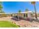 Charming home featuring rock landscaping and a covered front patio with furniture at 17200 W Bell Rd # 2189, Surprise, AZ 85374