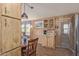 Kitchen featuring wood cabinets and adjacent living area at 17200 W Bell Rd # 2189, Surprise, AZ 85374