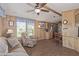 Comfortable living room featuring wood paneling and stainless steel appliances in adjacent room at 17200 W Bell Rd # 2189, Surprise, AZ 85374
