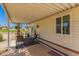 Cozy covered patio for enjoying shade and outdoor dining, with a view of the landscaped yard at 17200 W Bell Rd # 2189, Surprise, AZ 85374