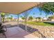 This covered patio showcases decorative pillars and hardscaping with mature trees in the background at 17200 W Bell Rd # 2189, Surprise, AZ 85374