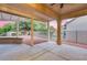 Covered back patio with ceiling fan and view of the landscaped backyard and fencing at 17911 N Adobe Mesa Ct, Surprise, AZ 85374