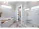 Stylish bathroom featuring a glass shower, soaking tub, and modern fixtures with natural light at 17911 N Adobe Mesa Ct, Surprise, AZ 85374