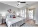 Bright bedroom featuring a ceiling fan, neutral colors, and a comfortable bed with stylish throw pillows at 17911 N Adobe Mesa Ct, Surprise, AZ 85374