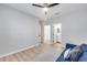 Bedroom featuring wood floors, a ceiling fan, and access to a bathroom and walk-in closet at 17911 N Adobe Mesa Ct, Surprise, AZ 85374