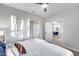 Bedroom boasts a cozy bed, modern ceiling fan, and an open doorway leading to another room at 17911 N Adobe Mesa Ct, Surprise, AZ 85374