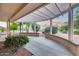 Charming covered patio offers a peaceful view of the garden and backyard, creating a serene escape at 17911 N Adobe Mesa Ct, Surprise, AZ 85374