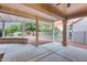 Large covered patio overlooking the serene, fenced backyard and lush landscape with desert rocks at 17911 N Adobe Mesa Ct, Surprise, AZ 85374