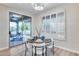 Cozy dining area with modern lighting, sliding glass doors, and plantation shutters, creating a charming dining space at 17911 N Adobe Mesa Ct, Surprise, AZ 85374